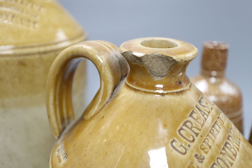 A pair of stoneware vessels, a G. Crease & Son Wine and Spirit Merchants vessel, and a G & C A Bennett ditto